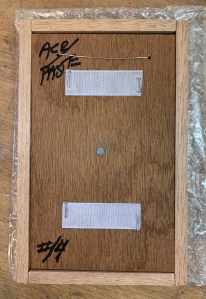 The back side of a finished panel with the backing plate screwed into place.