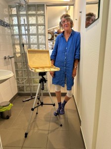 The pochade box mounted to a camera tripod. Titling mechanism in place, lid ready for an unpainted panel.