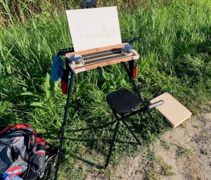 Original version of cheap field easel, funky palette and cheap chair.